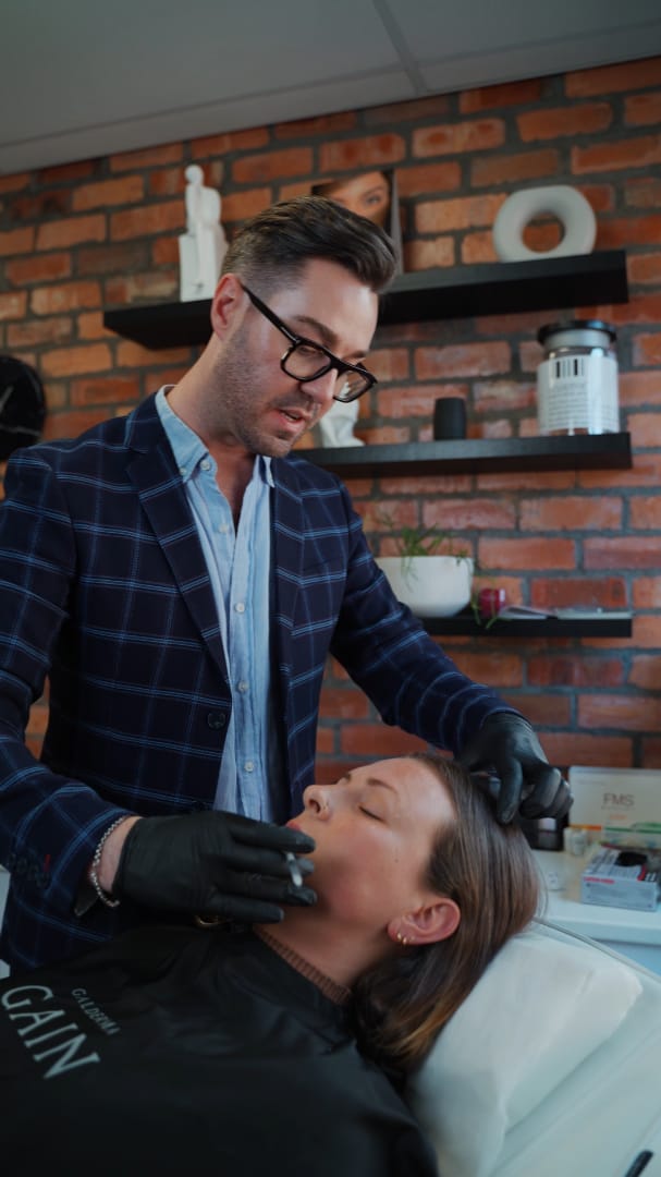Dr Juan Bester performing a professional skin consultation for a patient at LightSculpt