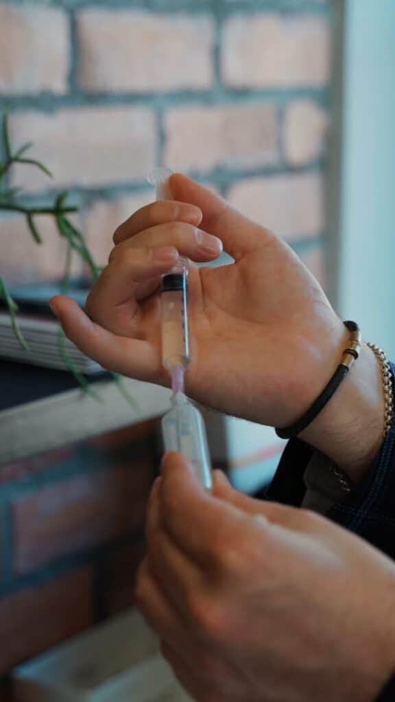 The LightSculpt Standard: Medically Led Aesthetic Care 1 Medically led aesthetic care at LightSculpt with a syringe being prepared by a trained practitioner