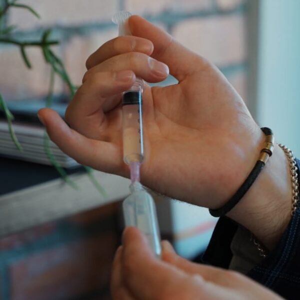 Medically led aesthetic care at LightSculpt with a syringe being prepared by a trained practitioner